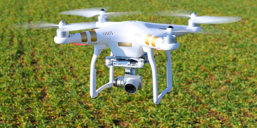 PILSEN CZECH REPUBLIC – FEBRUARY 18, 2016: Drone quadrocopter Dj DJI Phantom drone scanning a crop field